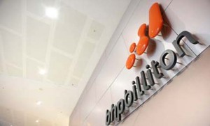 BHP Billiton Ltd. signage is mounted on a wall in the lobby of the company's headquarters in Melbourne, Australia, on Friday, July 15, 2011. BHP Billiton Ltd., the world's largest mining company, agreed to acquire Petrohawk Energy Corp. for about $12.1 billion in cash in its biggest acquisition, betting natural gas demand will gain in the U.S. Photographer: Carla Gottgens/Bloomberg